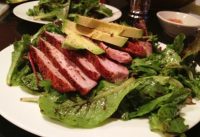 Grilled Pork Loin over Herb Mixed Greens